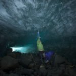 Measuring melting, researchers Brooke Stamper and Mira Dutschke use a tamp measure to record Glacier Cave depth under the Lewellyn Glacier in Canada. The Juneau Icefield Research Program, one of the longest running climate data records in the world, and an outdoor classroom that has trained environmental scientists since 1946.