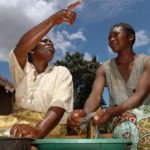 Esnart Nkhona washes clothes next to her sisetr in law, Fanie Mbewe, 26- a woman who has gone through a ritual cleansing, where a man from the village is apppointed to sleep with her after the death of her husband. She is at her house near the Malawian town of Mchinji, near the border with Zambia in the east of the country.